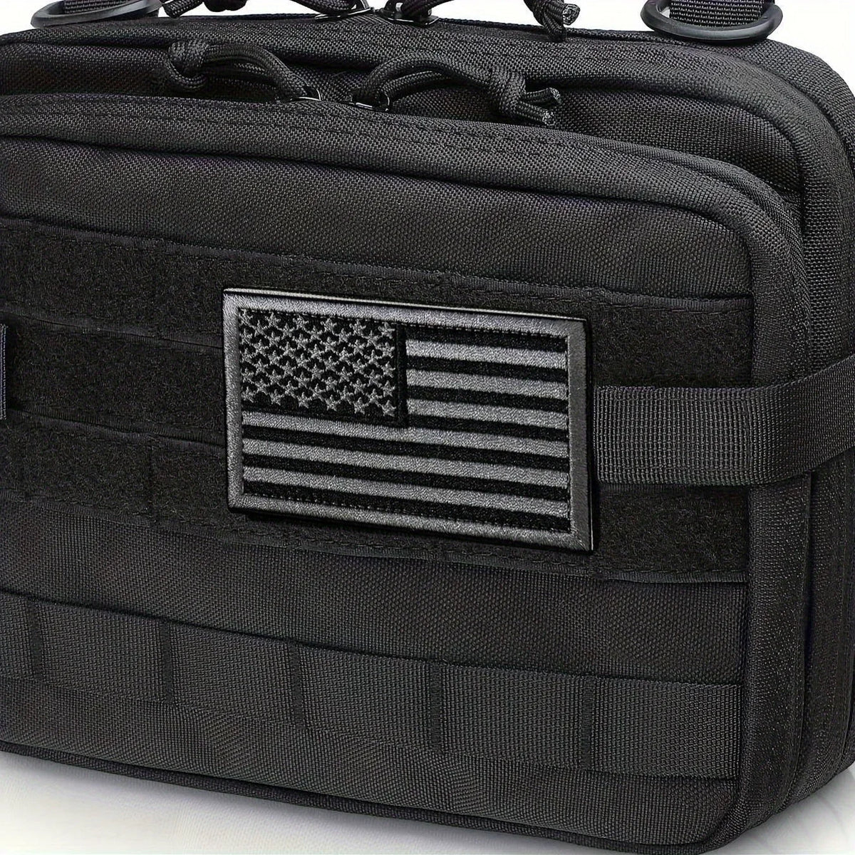 Tactical black flag patch set with an American flag embroidery displayed on a black fabric pouch.