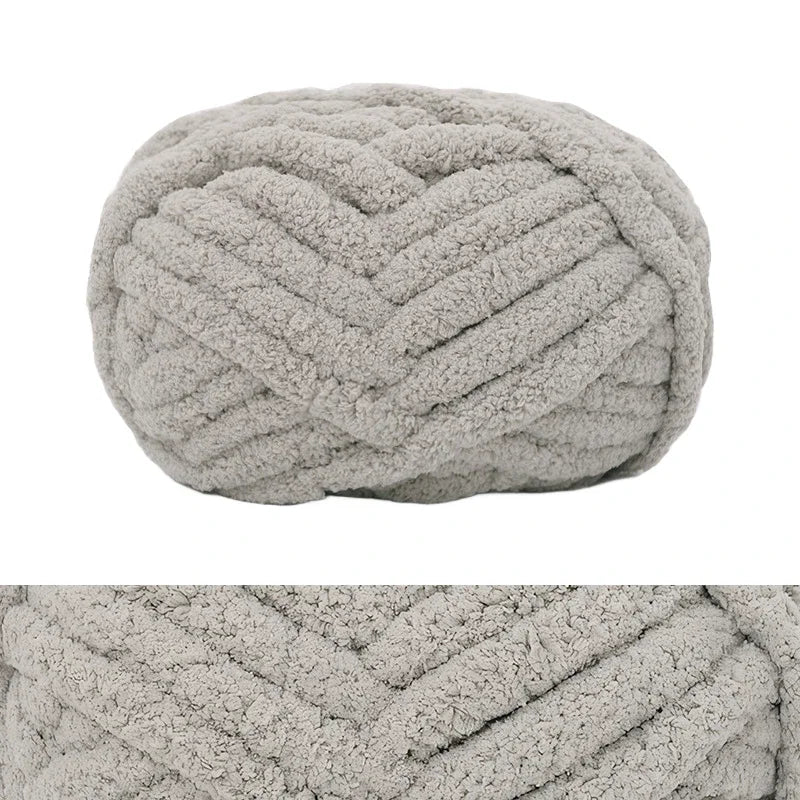 A ball of light gray chunky chenille yarn with a textured, ribbed pattern.