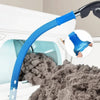 A blue flexible vacuum hose is shown connected to a dryer vent cleaning tool, with lint being removed from the dryer interior