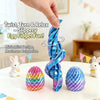 A hand twists a blue fidget toy shaped like an egg, demonstrating the twist turn and relax feature.