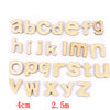 A set of wooden alphabet letters from a Montessori busy board for fine motor skills practice