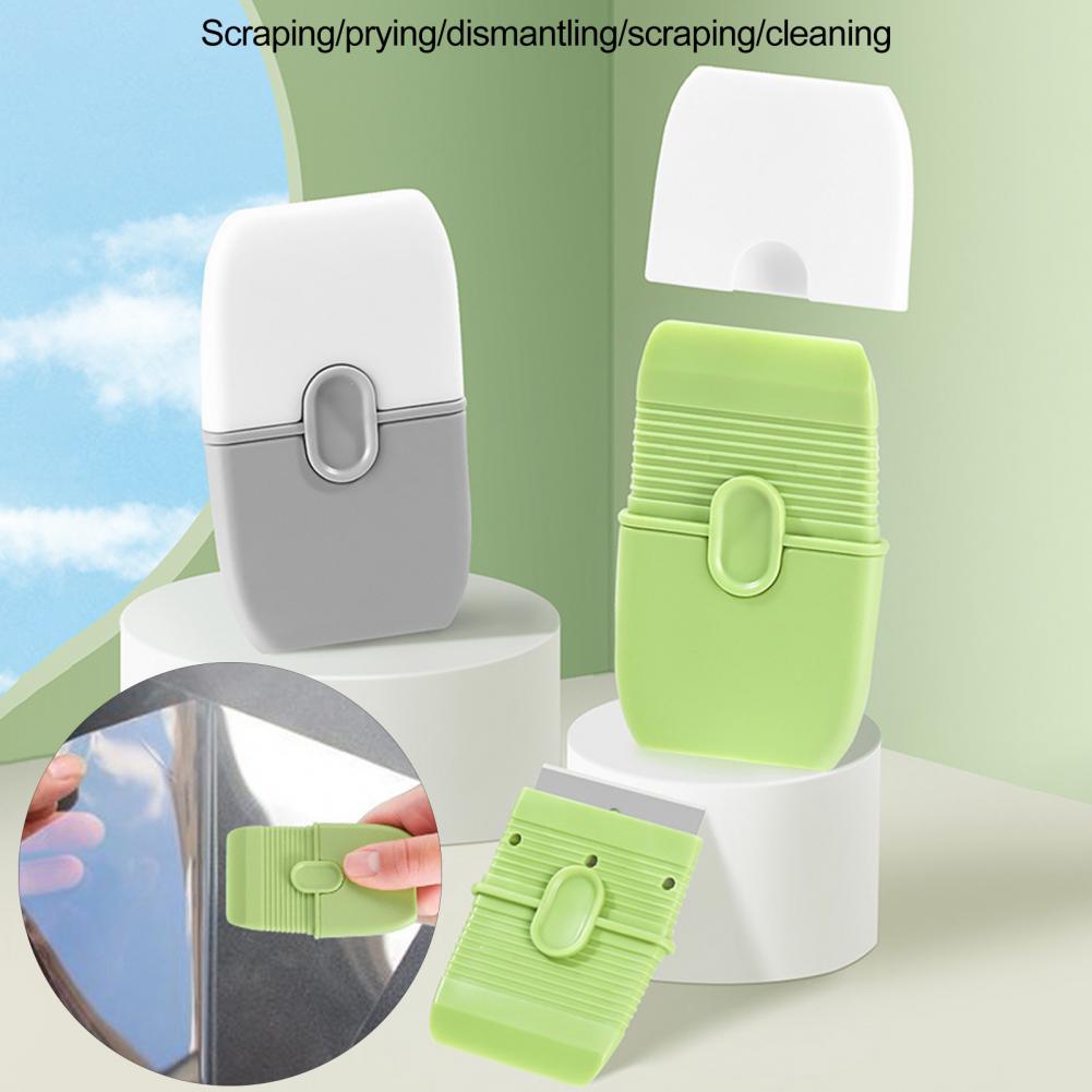A white double-ended cleaning scraper with a green protective cover and a white storage case are shown.