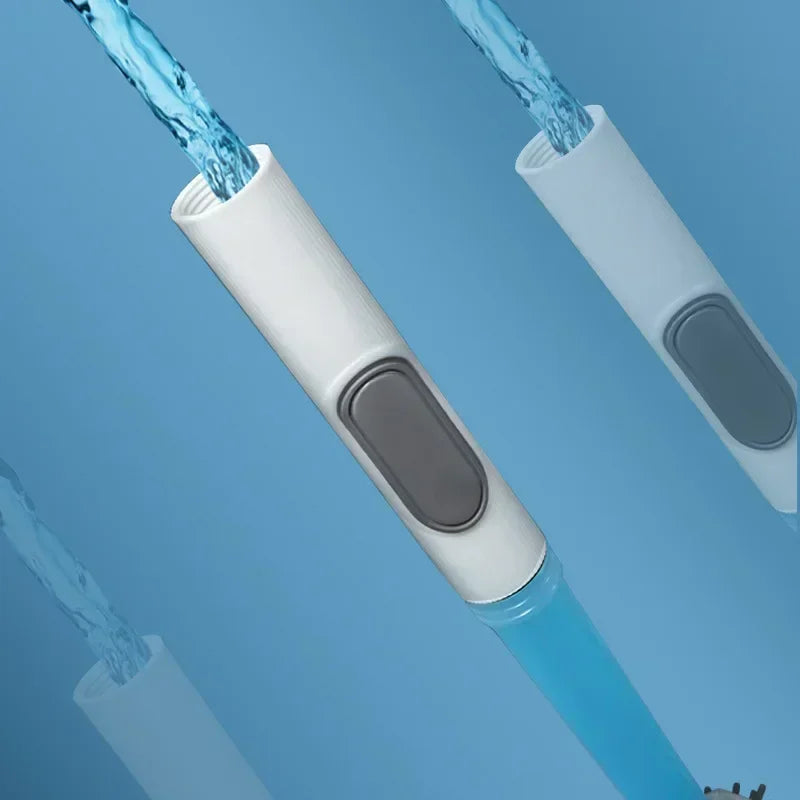 A close-up view of a white refillable toilet brush set with a wall-mounted holder and blue water flowing from the bristles.