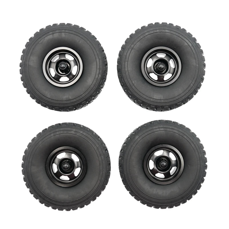 Four black RC car upgrade wheels with metal rims and soft tires shown from above.