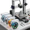 A clear airtight storage box for filament, featuring various materials like PLA, PETG, TPU, and PA, mounted on a 3D printer f