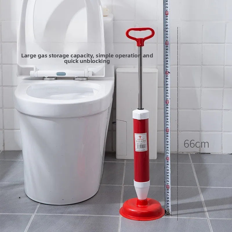 A red and white heavy-duty toilet plunger is shown next to a white toilet bowl.