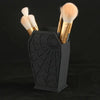Black coffin-shaped makeup brush holder with a spider web design and gold handles