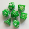 A collection of seven green pearl pattern polyhedral dice scattered on a white surface.