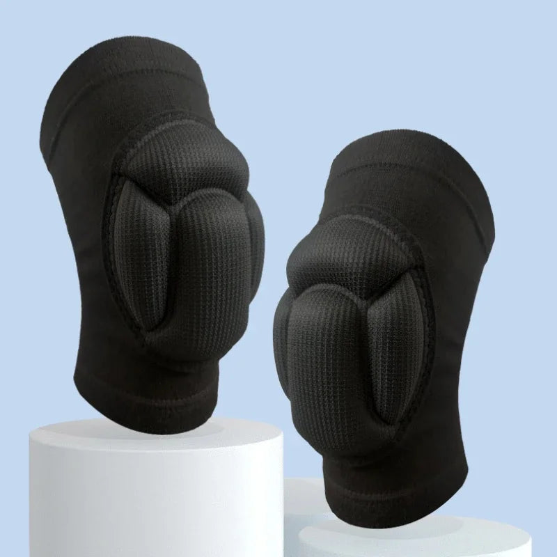 A pair of black thickened sports knee pads shown from the back, resting on a white display stand.