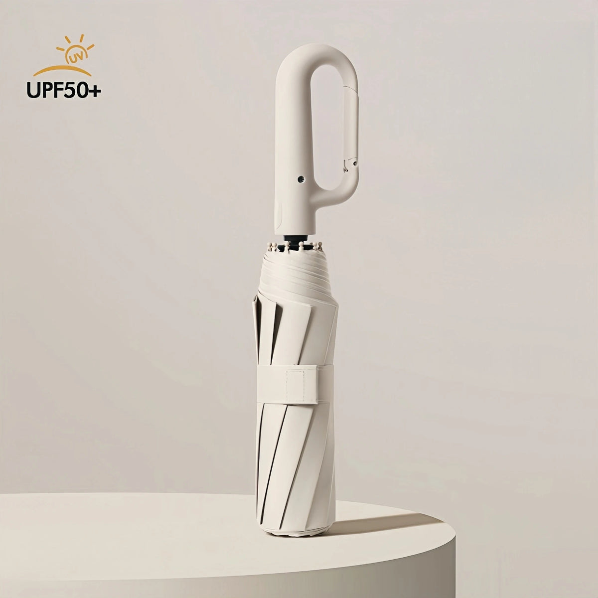 A white fully automatic windproof folding umbrella standing upright on a light surface.