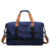 Navy blue large capacity water-resistant travel duffle bag with brown handles and black accents