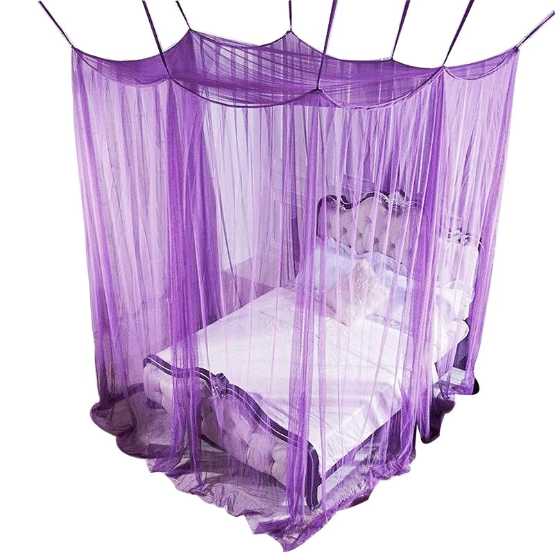Purple mosquito net bed canopy with a white bed inside, suspended by strings.