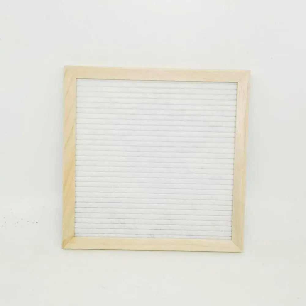 Una pizarra de fieltro rectangular con un marco de madera clara y líneas de cuadrícula blancas.