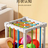 A white cube sorter with colorful elastic bands and various fruit shapes, demonstrating a sorting method for children.