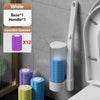 Wall-mounted disposable toilet brush set with white and lavender scented replacement heads displayed against a gray wall.