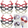 A collection of various fashion doll glasses and eyewear accessories in red, black, and white plastic.