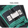 A silver tool hook is attached to a black canvas bag with green cord, used for securing tools.