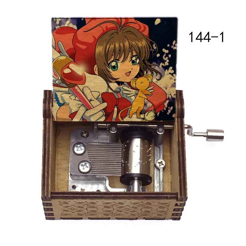 A music box featuring Cardcaptor Sakura characters, including Sakura Kin, with a hand crank mechanism.