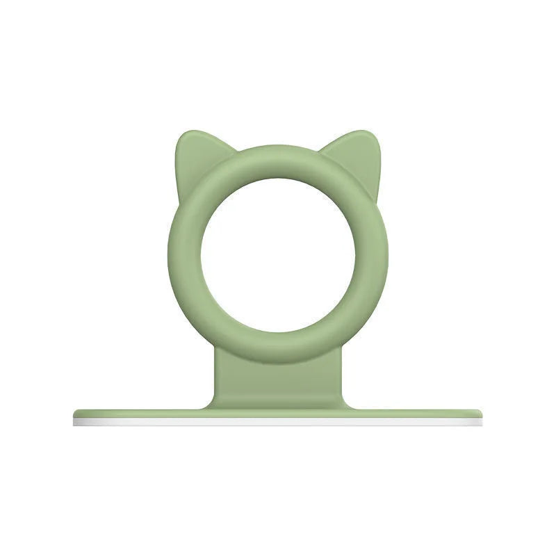A light green silicone toilet lid lifter with a self-adhesive hook.