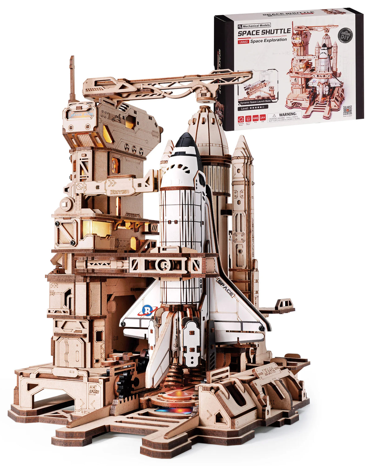 A detailed wooden model kit of a space shuttle with an accompanying launch simulator and display stand.