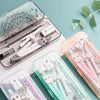 A collection of clear plastic tools including rulers, compasses, and protractors for geometry drawing.