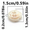 A small, oval-shaped ceramic fish bead with a light, translucent color.