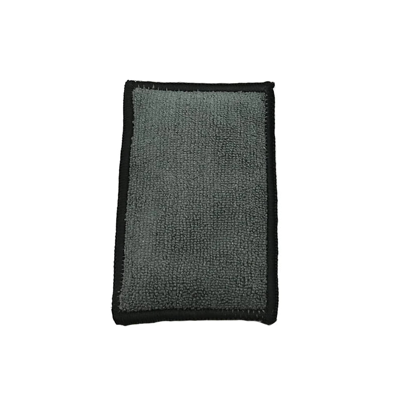 A rectangular dual-sided microfiber scrubbing sponge with a gray textured surface and black edges.