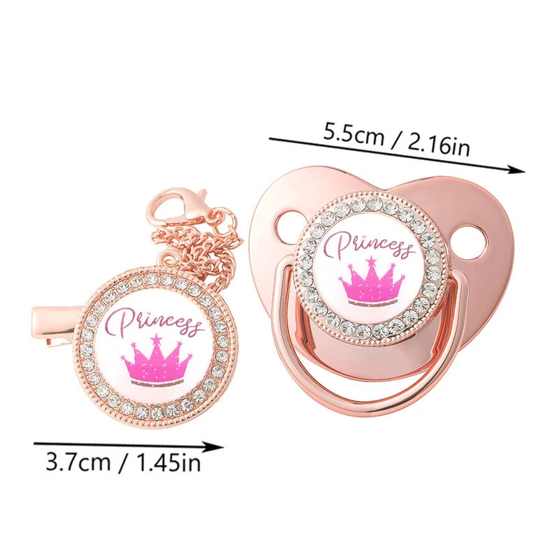 A pink crystal rhinestone pacifier chain clip set with a silicone nipple and a crown charm.