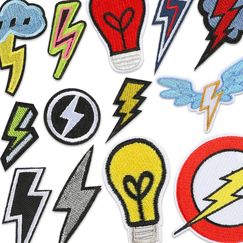 A collection of various lightning bolt iron-on embroidered patches in different colors and styles.
