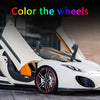 A white sports car with its wheels open, showing a red rim protector installed on the front wheel.