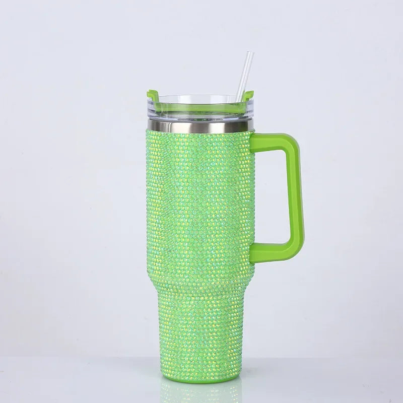 A bright lime green tumbler with a textured rhinestone pattern, featuring a metal lid and a handle.