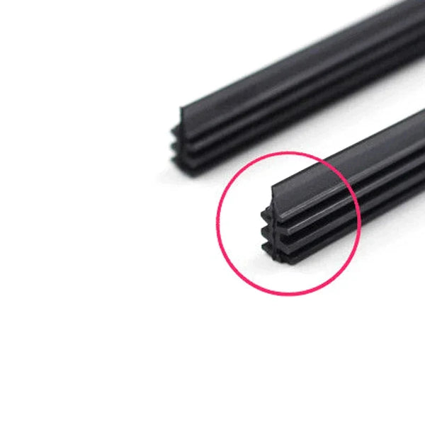 Close-up view of a black rubber wiper blade refill, showing the serrated edge.
