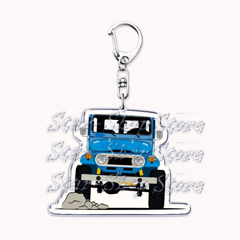 A silver metal key ring attached to a durable off-road truck keychain featuring a blue vehicle model.