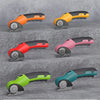 A collection of five cordless rotary scissors in various colors including orange, yellow, red, pink, and teal, shown from the