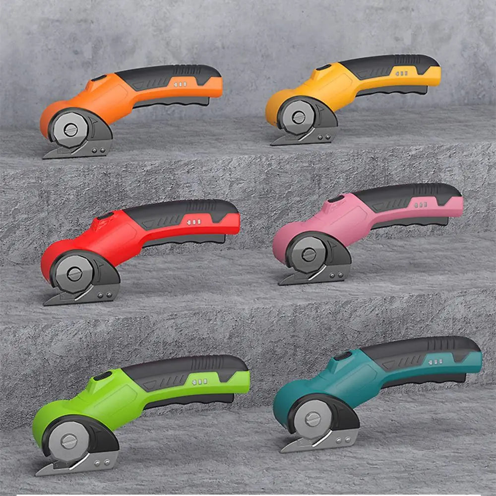 A collection of five cordless rotary scissors in various colors including orange, yellow, red, pink, and teal, shown from the