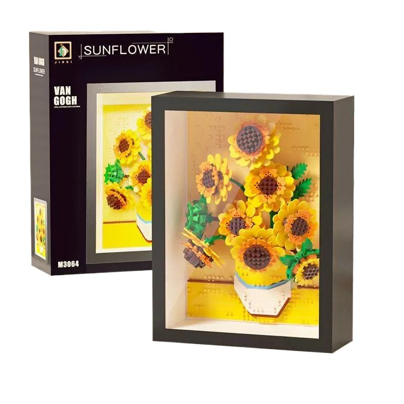 A framed yellow sunflower arrangement displayed in a black box.