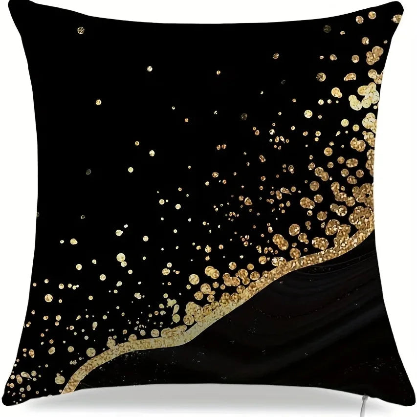 Black throw pillow cover with a scattered gold dot pattern.