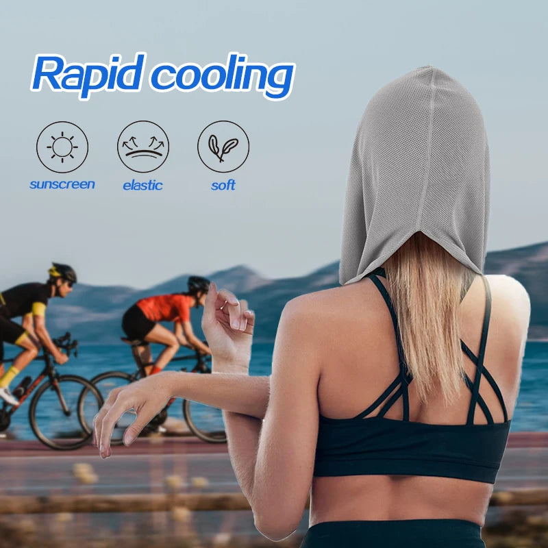 A person wearing a grey evaporative cooling hoodie towel is shown outdoors with cyclists in the background.