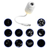 A white mini galaxy star projector night light with a flexible cord and various star patterns displayed on a dark background.