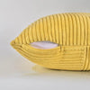 A yellow corduroy throw pillow cover with a cutout, showing the ribbed texture.