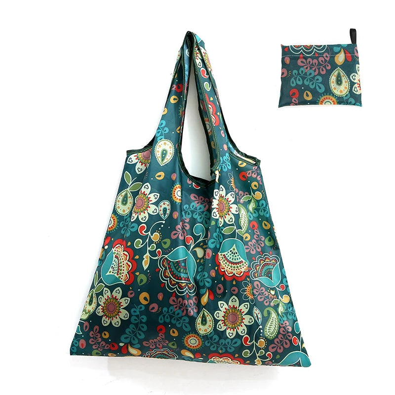 A teal patterned reusable shopping tote bag with a matching fabric carry pouch.