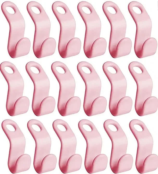 A set of pink cascading clothes hanger connector hooks used for space-saving wardrobe organization.