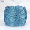 A ball of metallic blue silk crochet yarn with a shimmering texture for knitting and macrame.