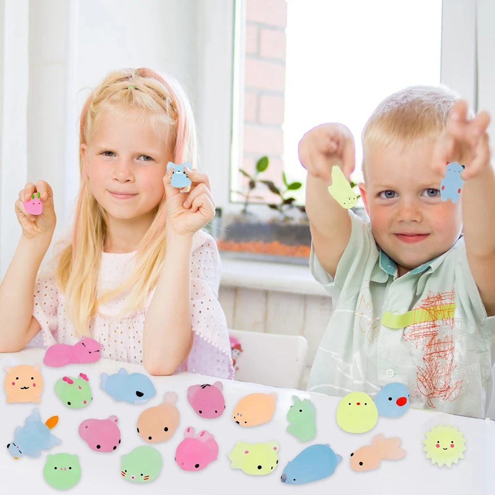A collection of colorful kawaii animal squishies and stress relief toys are displayed on a white surface.