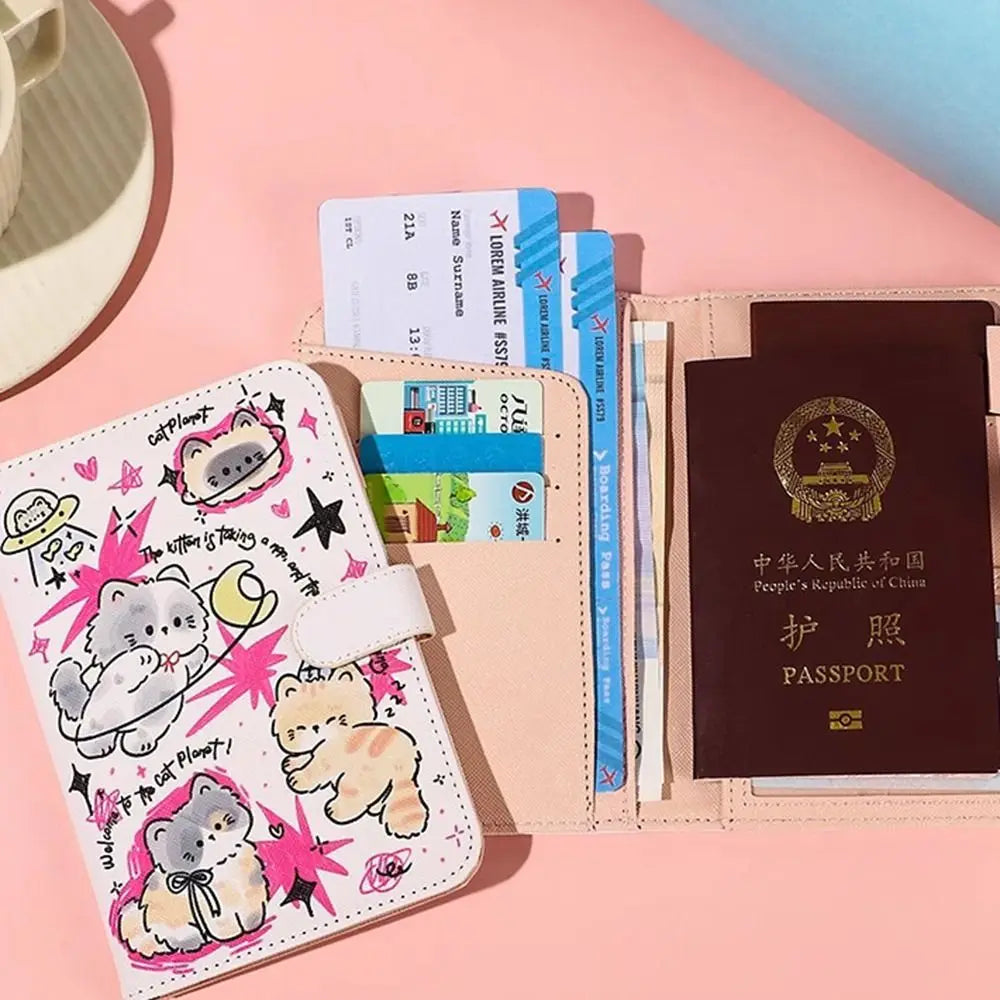 A pink and beige leather passport holder featuring a cartoon cat design and multiple passport cards.