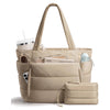 A beige quilted puffy tote bag with a laptop sleeve and a small zippered pouch.