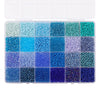A grid of multicolor acrylic rice beads in various shades of blue and green stored in a clear box.