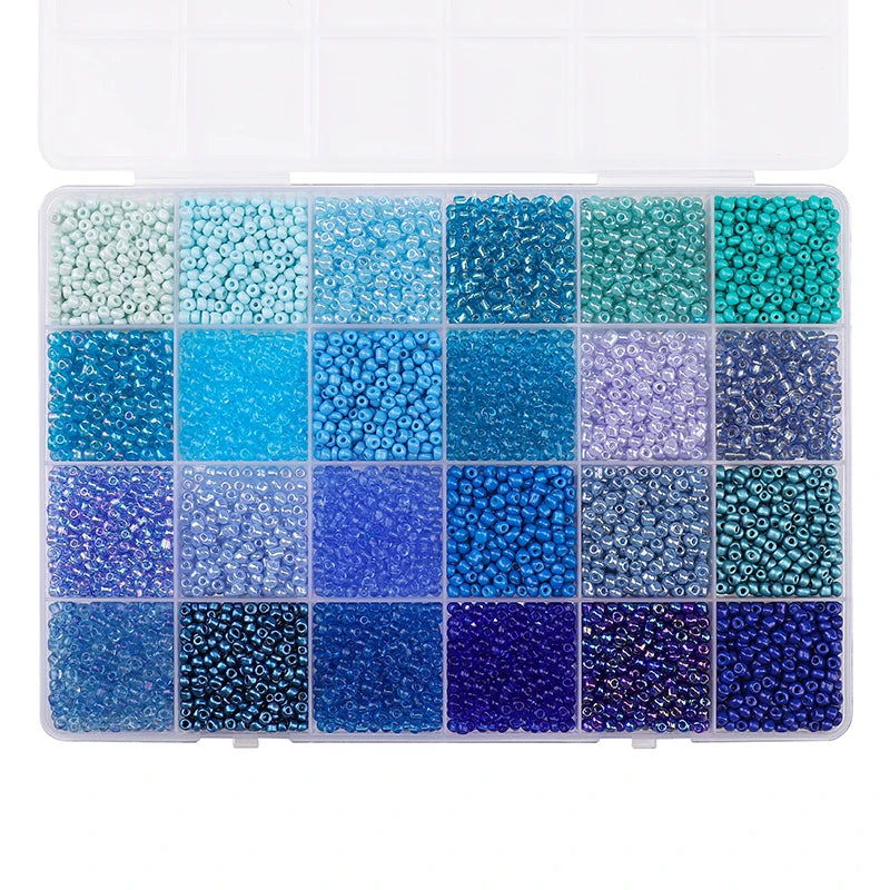 A grid of multicolor acrylic rice beads in various shades of blue and green stored in a clear box.