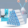 A stack of white and blue scented drawstring trash bags with handles is shown next to a plastic container.