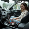 A woman sits in a car, holding a reusable car dehumidifier bag with a visual humidity indicator.